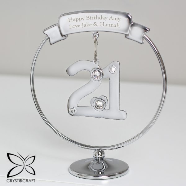 Mark their 21st Birthday with this elegant Crystocraft ornament. Dangling from a personalised round silver stand, is a crystal clad 21